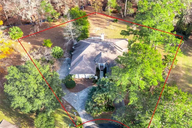 a backyard of a house with a yard and outdoor seating