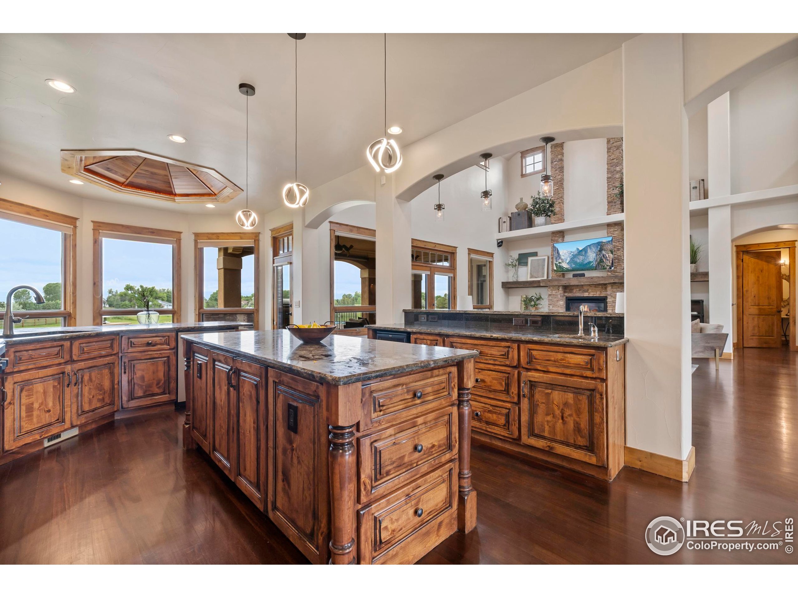 863 Riparian Way Fort Collins, CO 80524 - Photo 12 of 38 a kitchen with stainless steel appliances granite countertop a lot of counter space and wooden floors