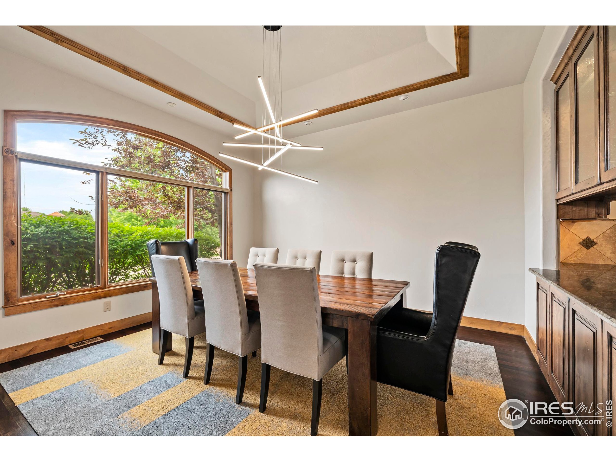 863 Riparian Way Fort Collins, CO 80524 - Photo 15 of 38 a view of a dining room with furniture window and wooden floor