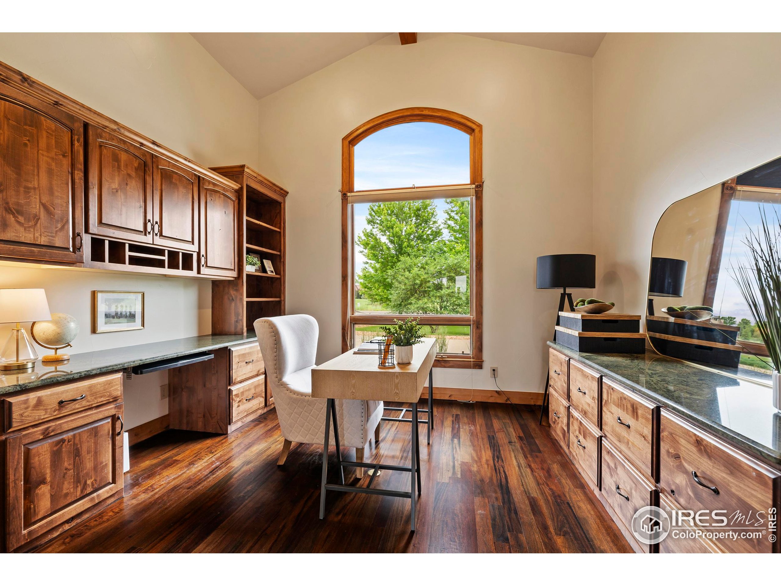 863 Riparian Way Fort Collins, CO 80524 - Photo 16 of 38 a kitchen with stainless steel appliances granite countertop a stove top oven a sink dishwasher and wooden cabinets with wooden floor
