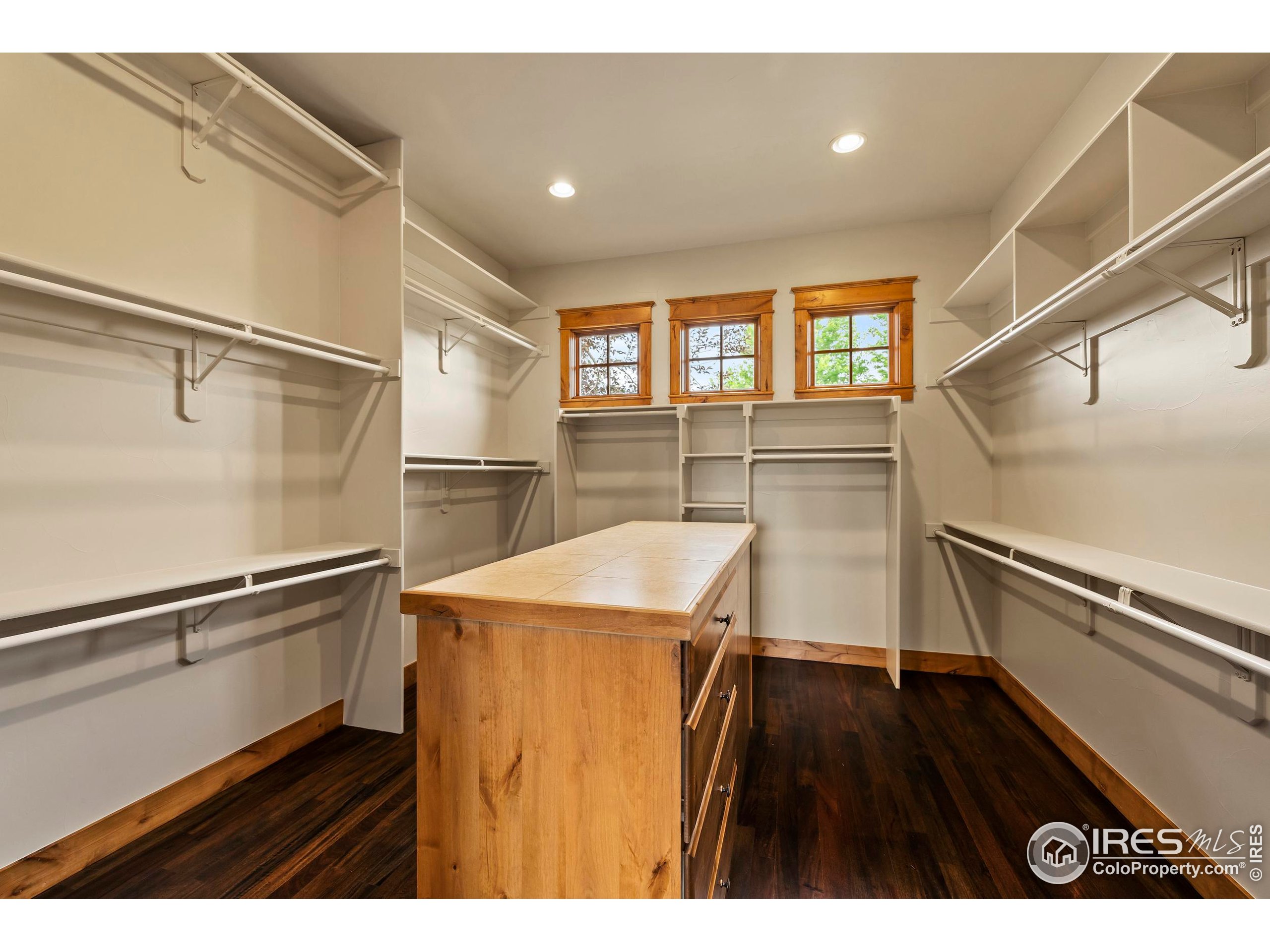 863 Riparian Way Fort Collins, CO 80524 - Photo 22 of 38 a hallway with a wooden floor and chairs
