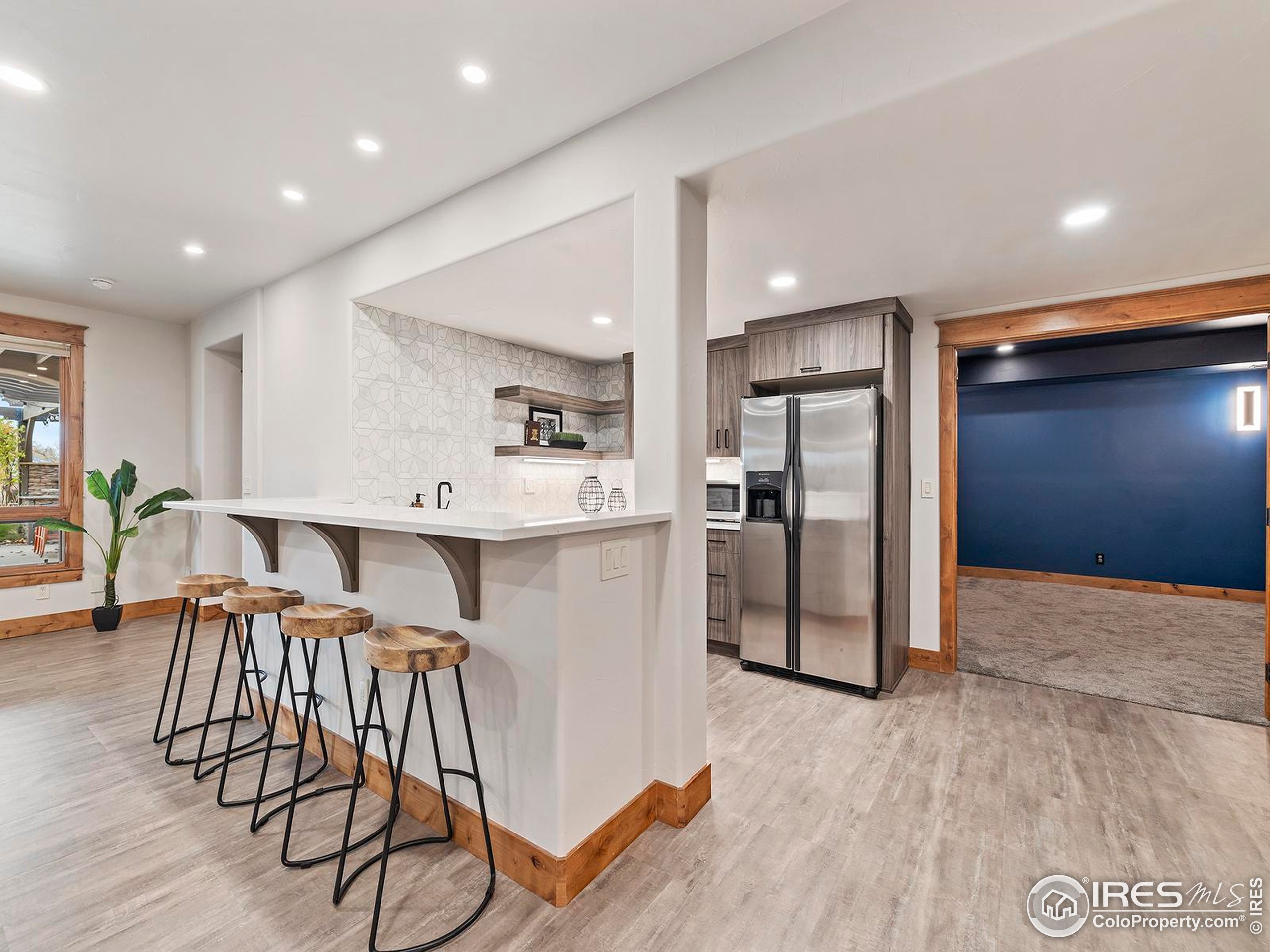 863 Riparian Way Fort Collins, CO 80524 - Photo 28 of 38 a kitchen with stainless steel appliances kitchen island granite countertop a refrigerator and a stove top oven