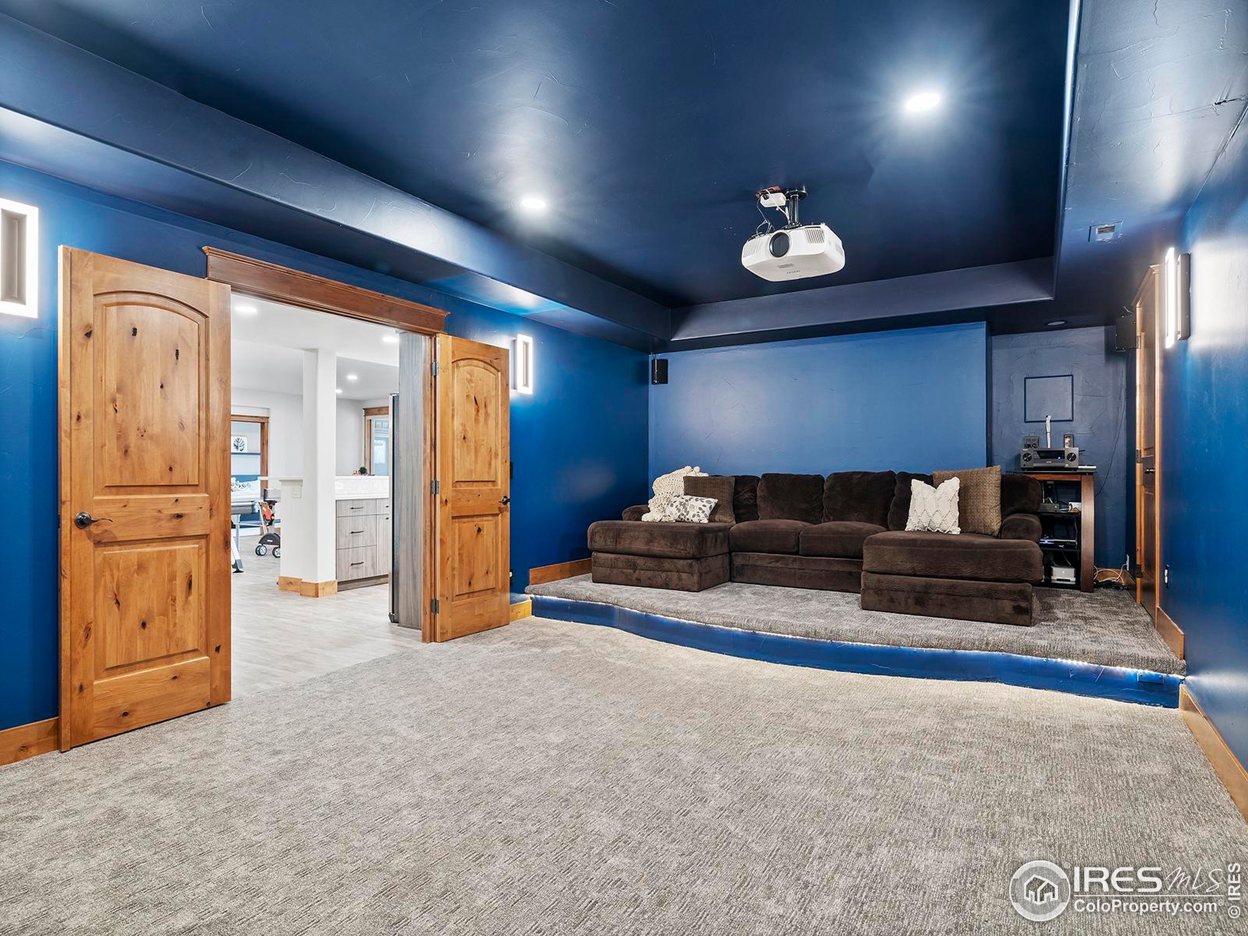 863 Riparian Way Fort Collins, CO 80524 - Photo 30 of 38 a living room with furniture and a chandelier
