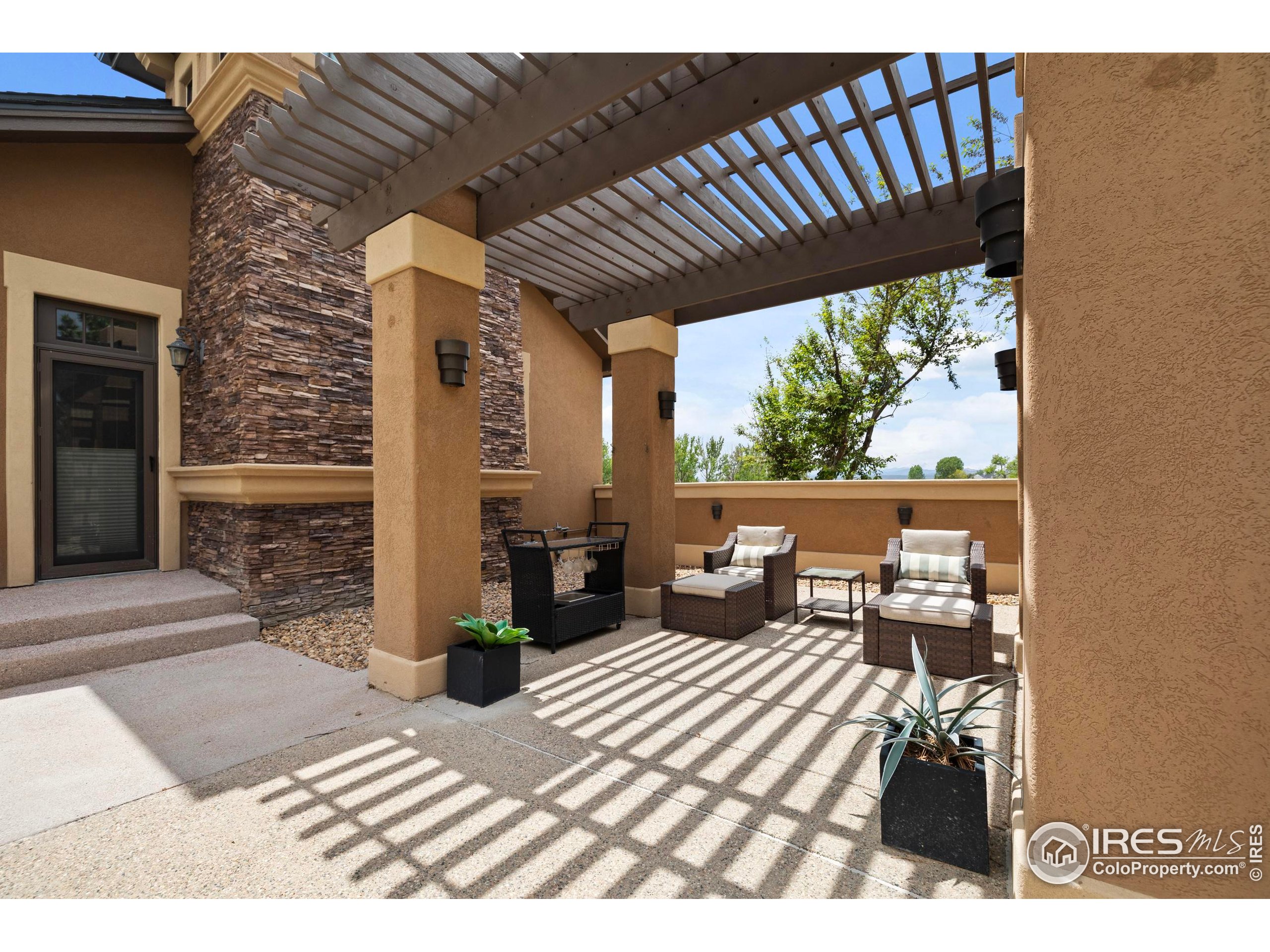 863 Riparian Way Fort Collins, CO 80524 - Photo 38 of 38 a view of a patio with table and chairs with wooden floor and fence