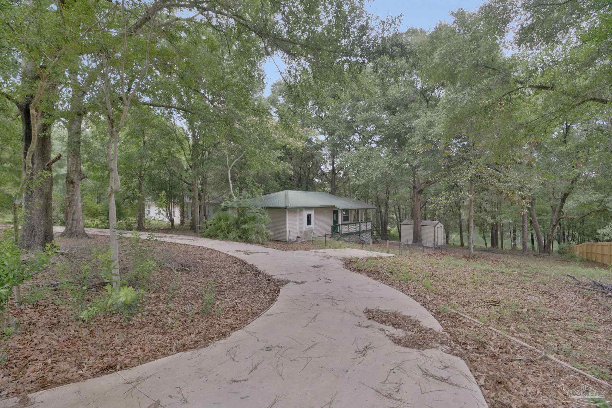 10290 West Lake Road Milton, FL 32583 - Photo 42 of 53 a view of a backyard with large trees