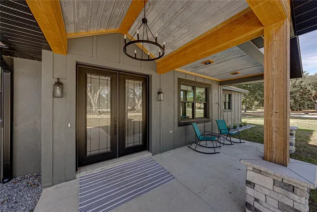a kitchen with stainless steel appliances a dining table chairs stove and refrigerator