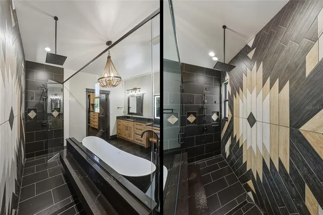 a kitchen with stainless steel appliances granite countertop a dining table chairs sink refrigerator and microwave