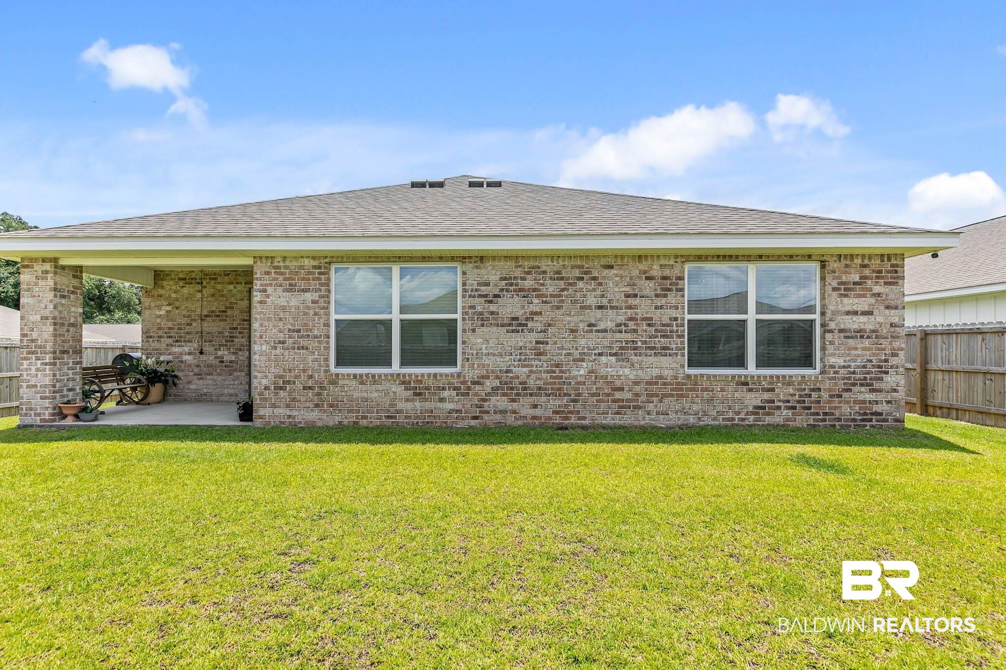 17217 REFLECTION Street Loxley, AL 36551 - Photo 43 of 83 Rear view of house featuring brick siding, a patio area, and roof with shingles