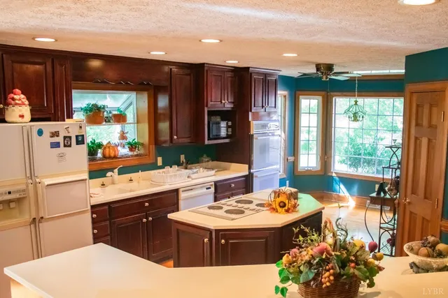 a kitchen with a stove a refrigerator and a dining table