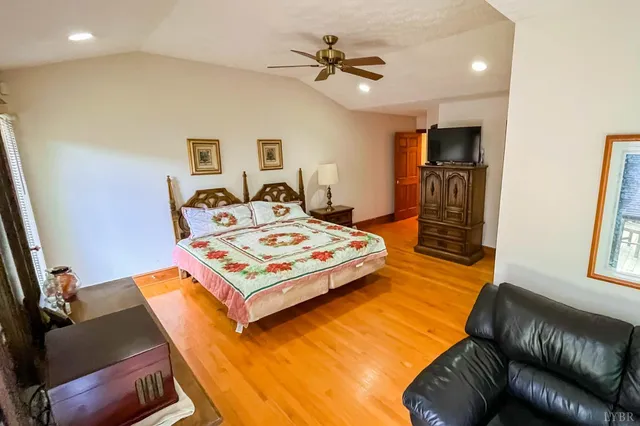 a living room with furniture a flat screen tv and a table