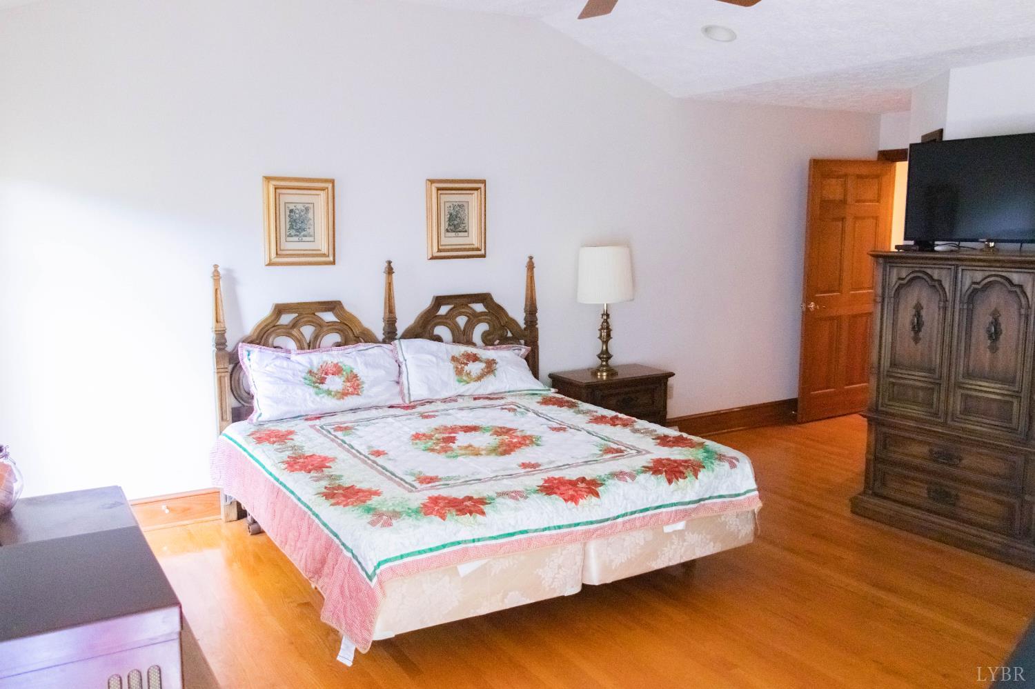 224 Walnut Road Danville, VA 24541 - Photo 18 of 54 a bedroom with a bed and flat screen tv