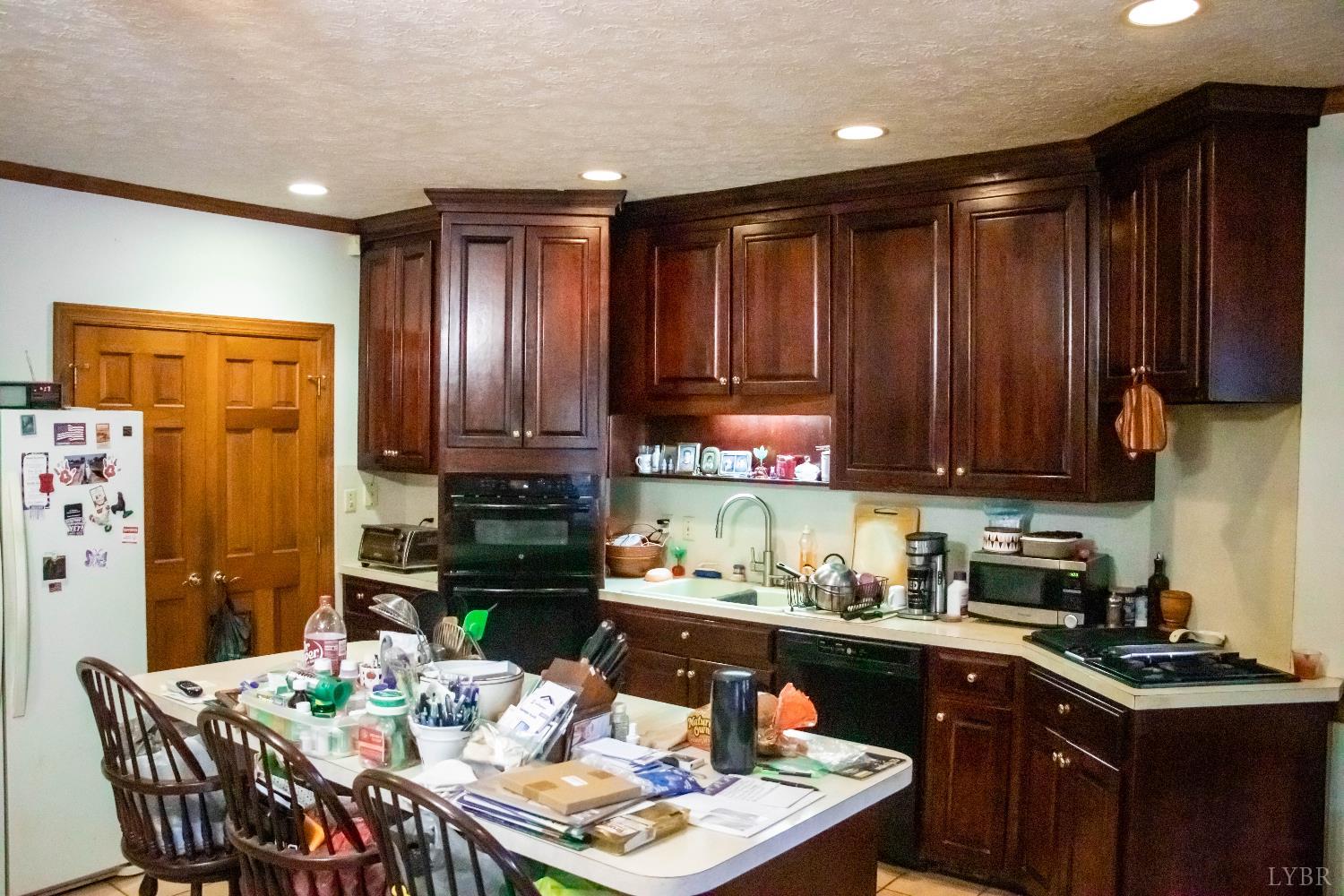 224 Walnut Road Danville, VA 24541 - Photo 35 of 54 a kitchen with stainless steel appliances granite countertop a refrigerator a stove a sink dishwasher and a dining table with garden view