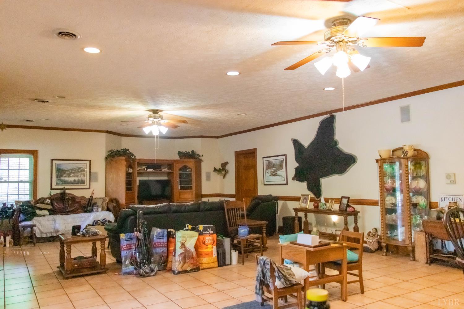 224 Walnut Road Danville, VA 24541 - Photo 37 of 54 a living room with lots of furniture and a chandelier