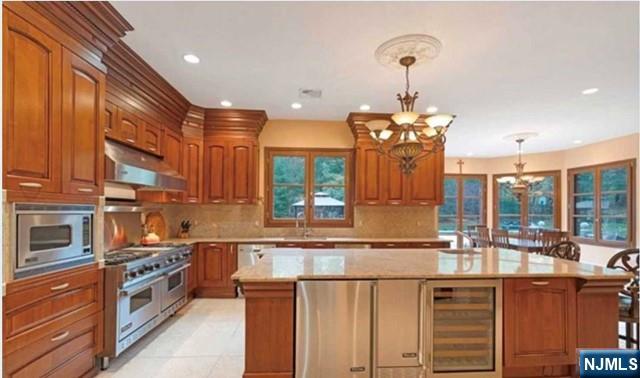 35 Timberline Drive Alpine, NJ 07620 - Photo 16 of 37 a kitchen with stainless steel appliances granite countertop a stove and a sink