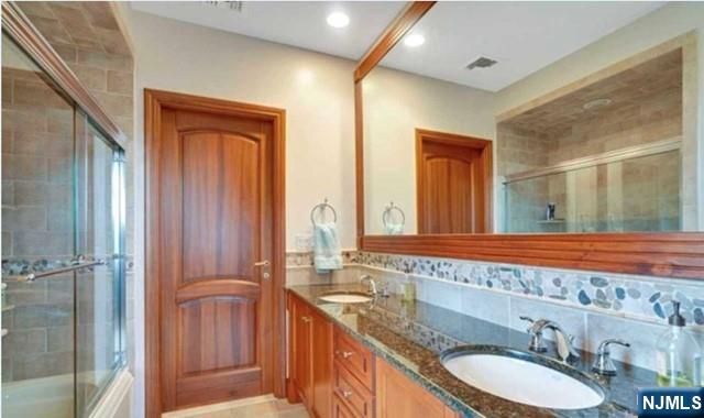 35 Timberline Drive Alpine, NJ 07620 - Photo 24 of 37 a bathroom with a granite countertop sink and a mirror
