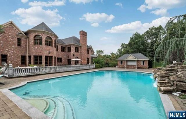 35 Timberline Drive Alpine, NJ 07620 - Photo 32 of 37 a view of a house with pool and chairs