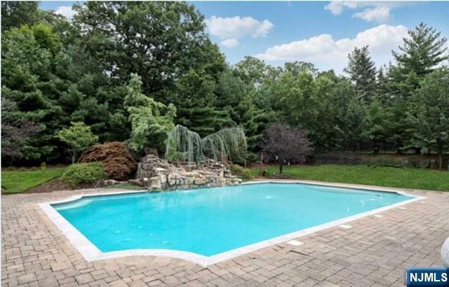 35 Timberline Drive Alpine, NJ 07620 - Photo 33 of 37 a view of a swimming pool with a yard