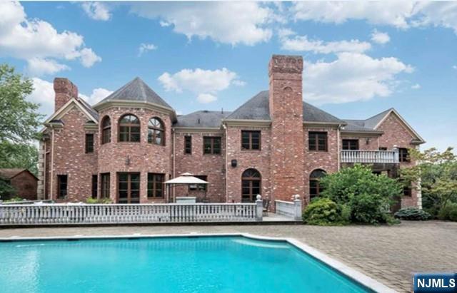 35 Timberline Drive Alpine, NJ 07620 - Photo 35 of 37 a front view of a house with a garden and lake view