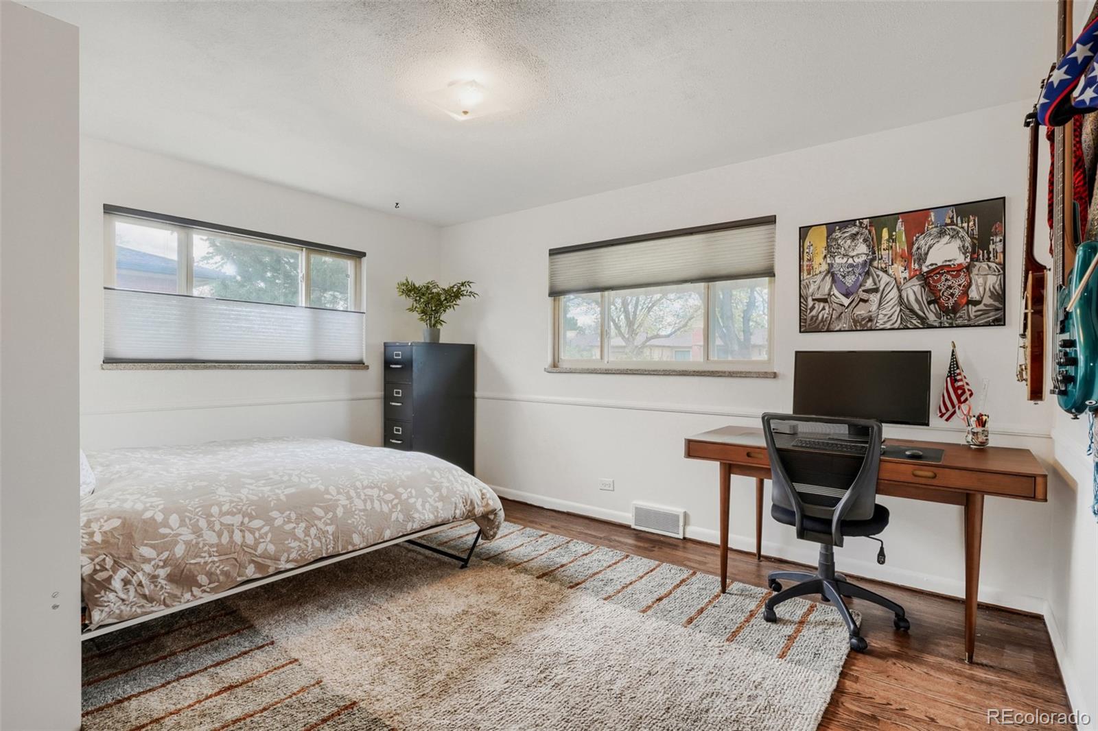 4560 Teller Street Wheat Ridge, CO 80033 - Photo 17 of 25 a bedroom with a bed and a desk