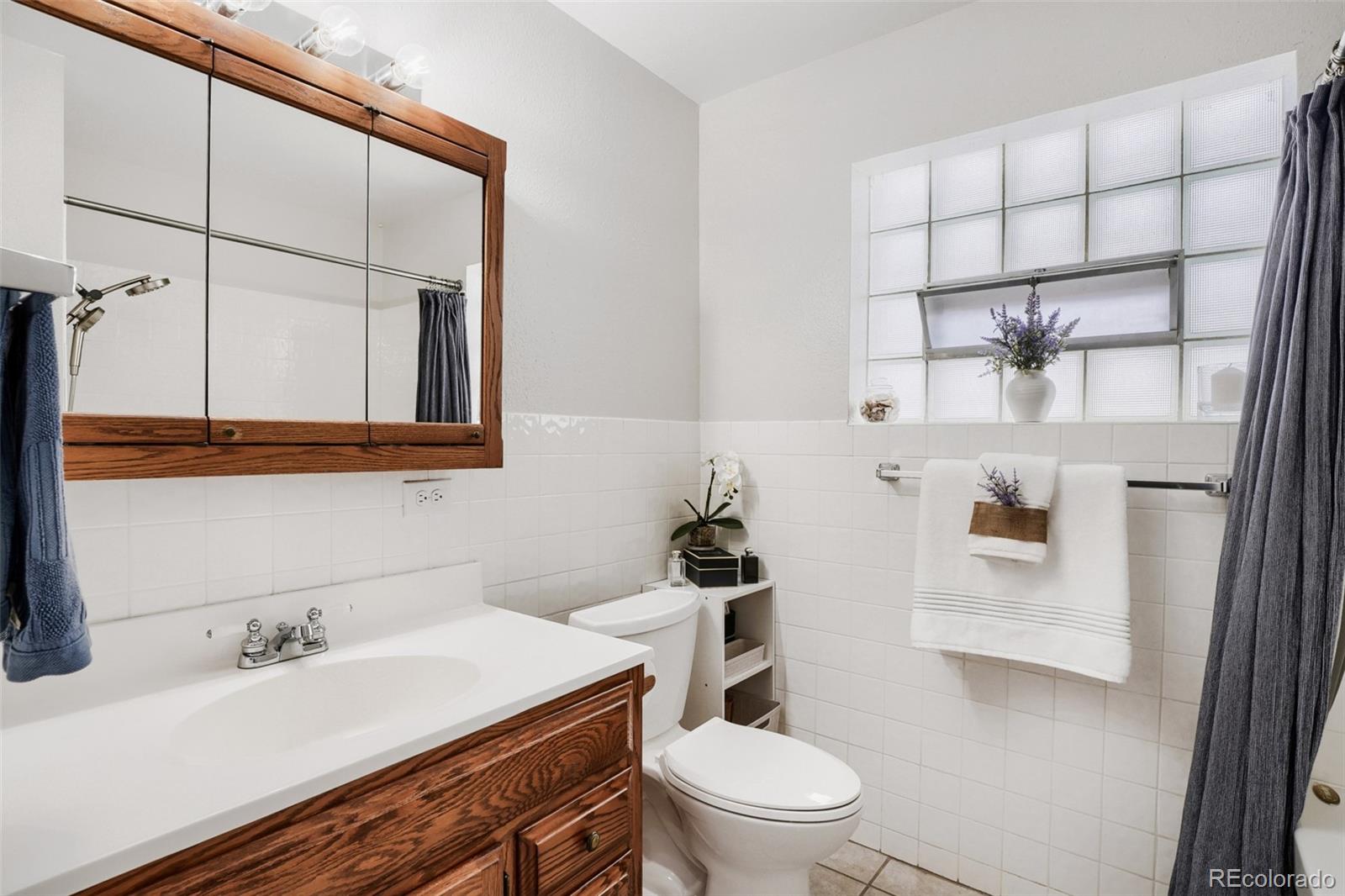 4560 Teller Street Wheat Ridge, CO 80033 - Photo 19 of 25 a bathroom with a sink toilet and mirror