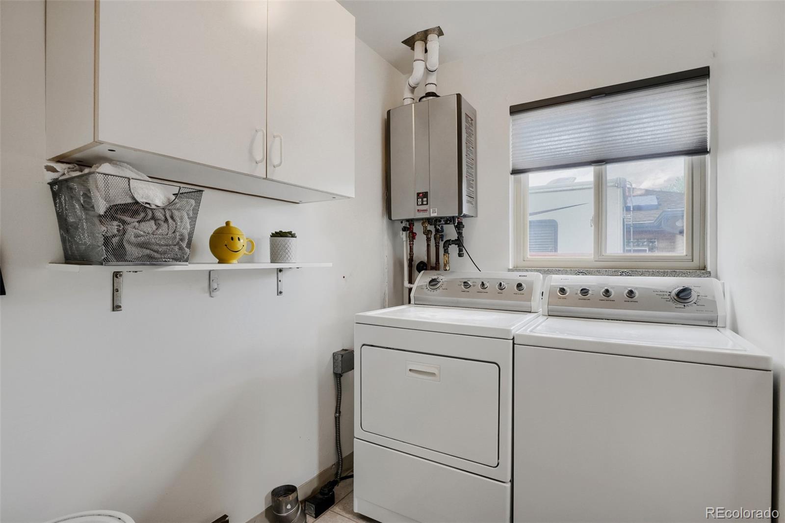 4560 Teller Street Wheat Ridge, CO 80033 - Photo 22 of 25 a view of storage and utility room with washer and dryer