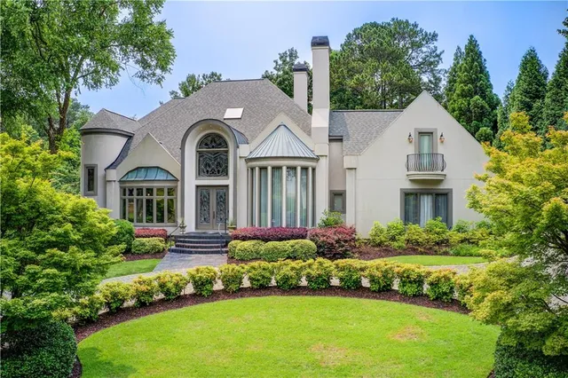 a front view of a house with a garden