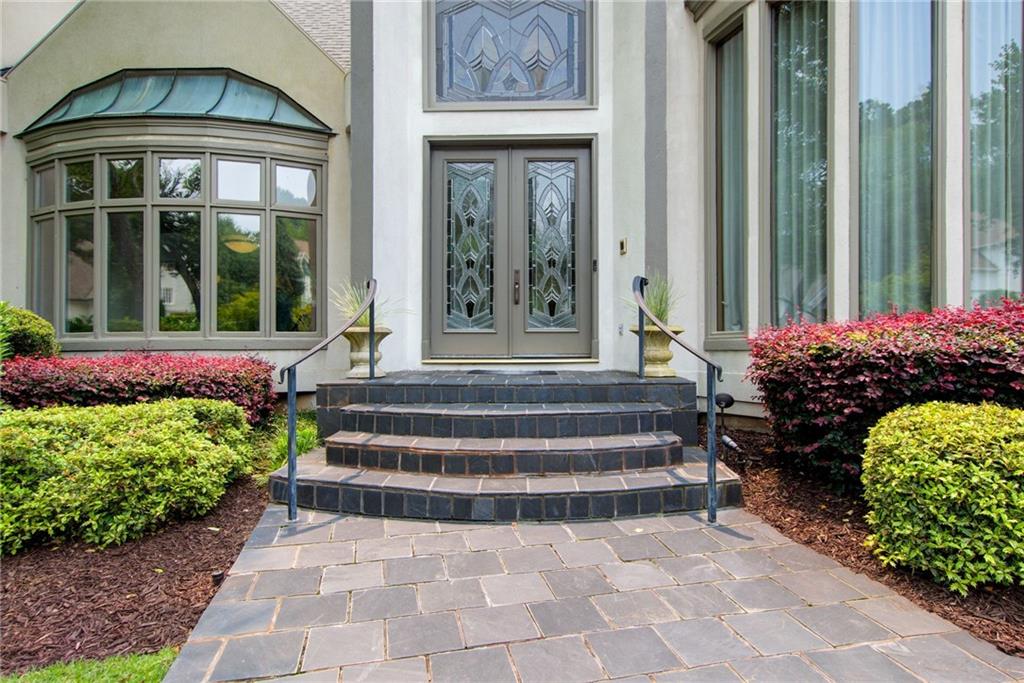 115 Cross Roads Court Atlanta, GA 30327 - Photo 2 of 55 a front view of a house with a garden