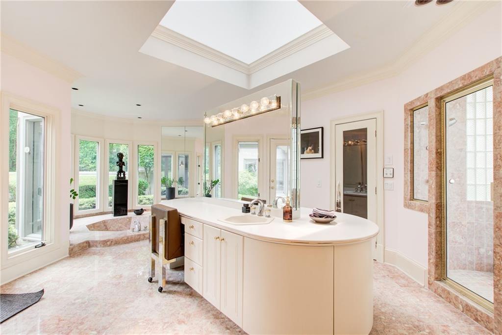 115 Cross Roads Court Atlanta, GA 30327 - Photo 25 of 55 a view of a very nice looking living room with a large window and chandelier