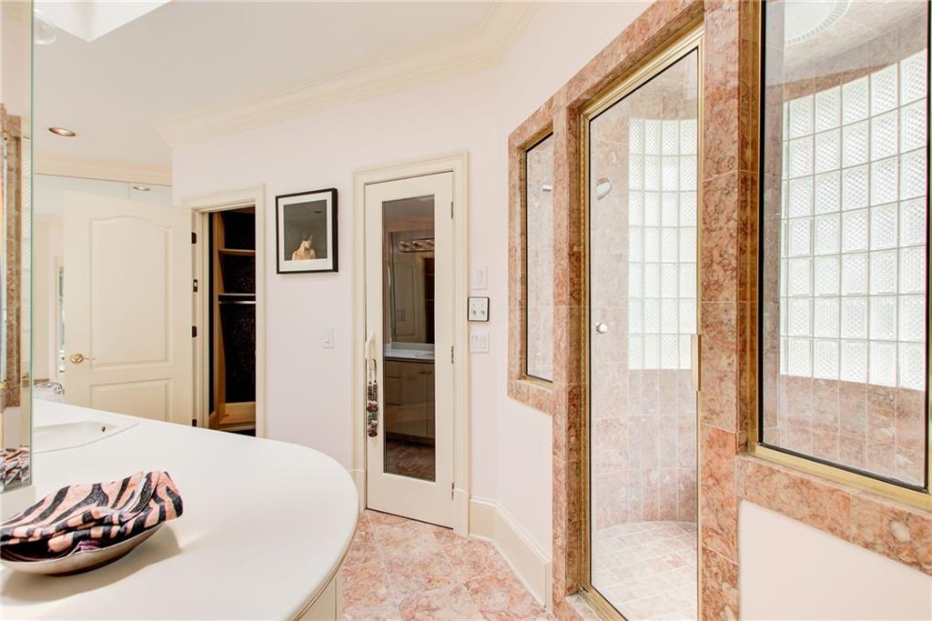 115 Cross Roads Court Atlanta, GA 30327 - Photo 26 of 55 a bedroom with a bed and a large mirror next to a large window