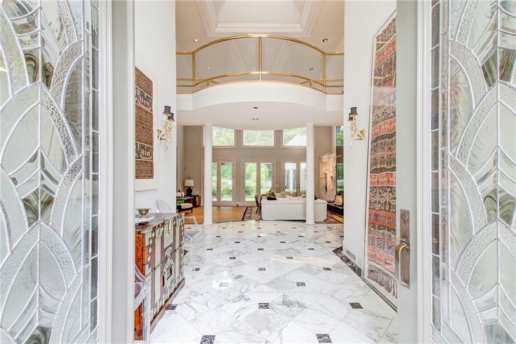 115 Cross Roads Court Atlanta, GA 30327 - Photo 3 of 55 a living room with a large window and a chandelier