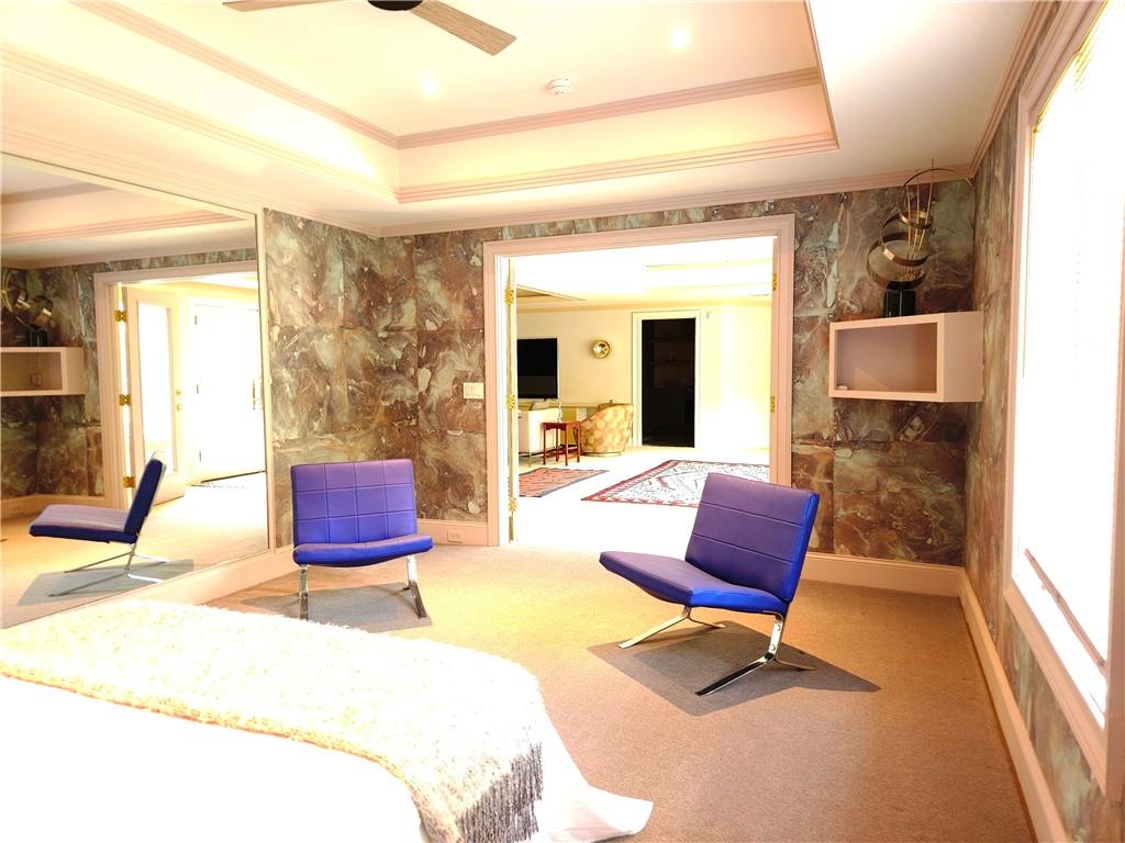 115 Cross Roads Court Atlanta, GA 30327 - Photo 41 of 55 a living room with furniture a rug and a floor to ceiling window