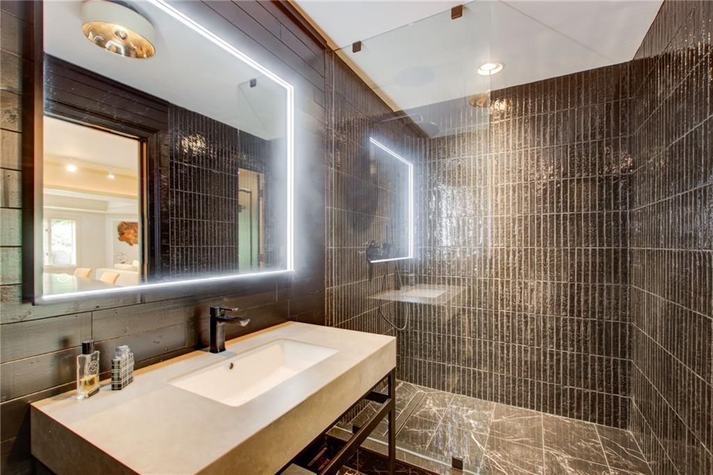 115 Cross Roads Court Atlanta, GA 30327 - Photo 43 of 55 a bathroom with a sink mirror and a shower