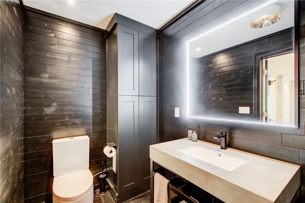 115 Cross Roads Court Atlanta, GA 30327 - Photo 44 of 55 a bathroom with a sink a toilet and mirror