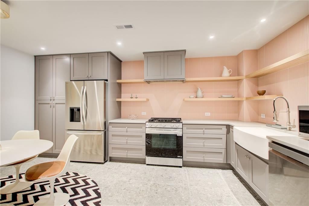 115 Cross Roads Court Atlanta, GA 30327 - Photo 45 of 55 a kitchen with stainless steel appliances a refrigerator sink and stove