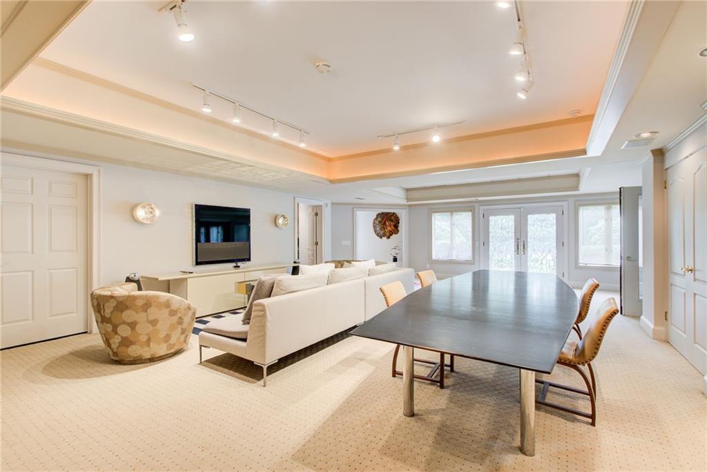 115 Cross Roads Court Atlanta, GA 30327 - Photo 47 of 55 a living room with furniture and a flat screen tv