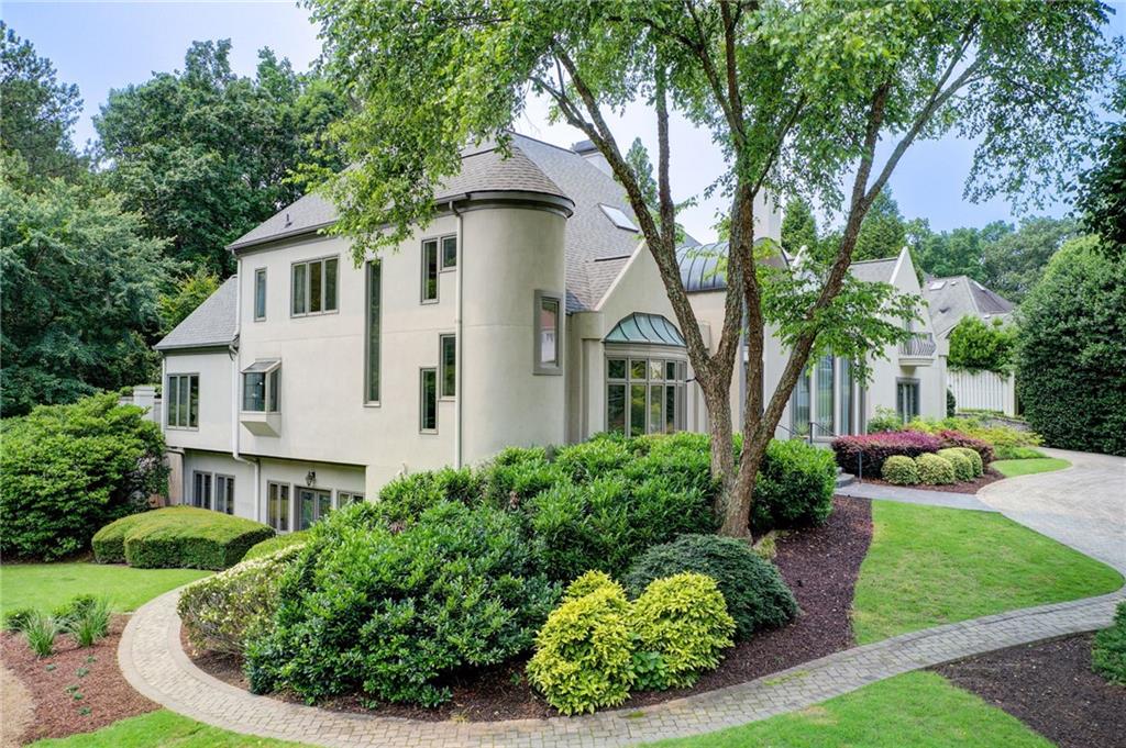 115 Cross Roads Court Atlanta, GA 30327 - Photo 49 of 55 a front view of a house with a yard and potted plants