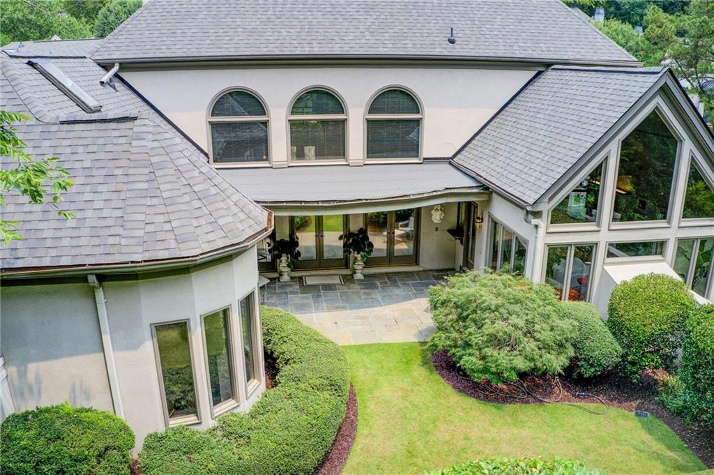 115 Cross Roads Court Atlanta, GA 30327 - Photo 51 of 55 a front view of a house with garden