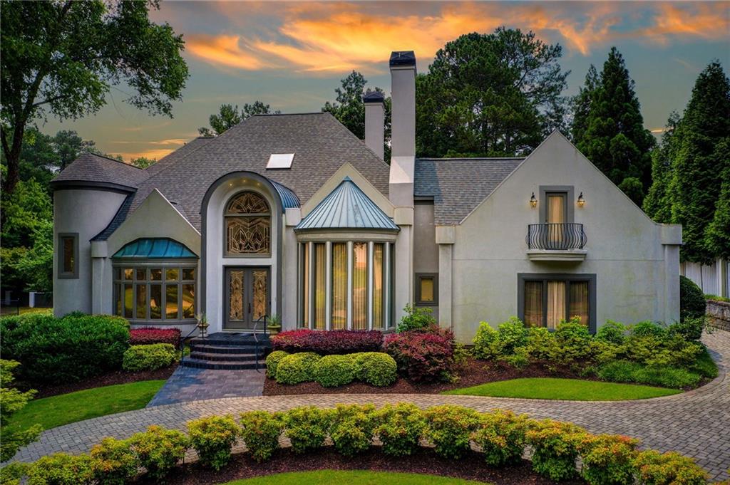 115 Cross Roads Court Atlanta, GA 30327 - Photo 55 of 55 a front view of a house with a garden