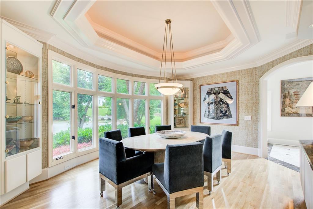 115 Cross Roads Court Atlanta, GA 30327 - Photo 8 of 55 a dining room with furniture a chandelier and wooden floor