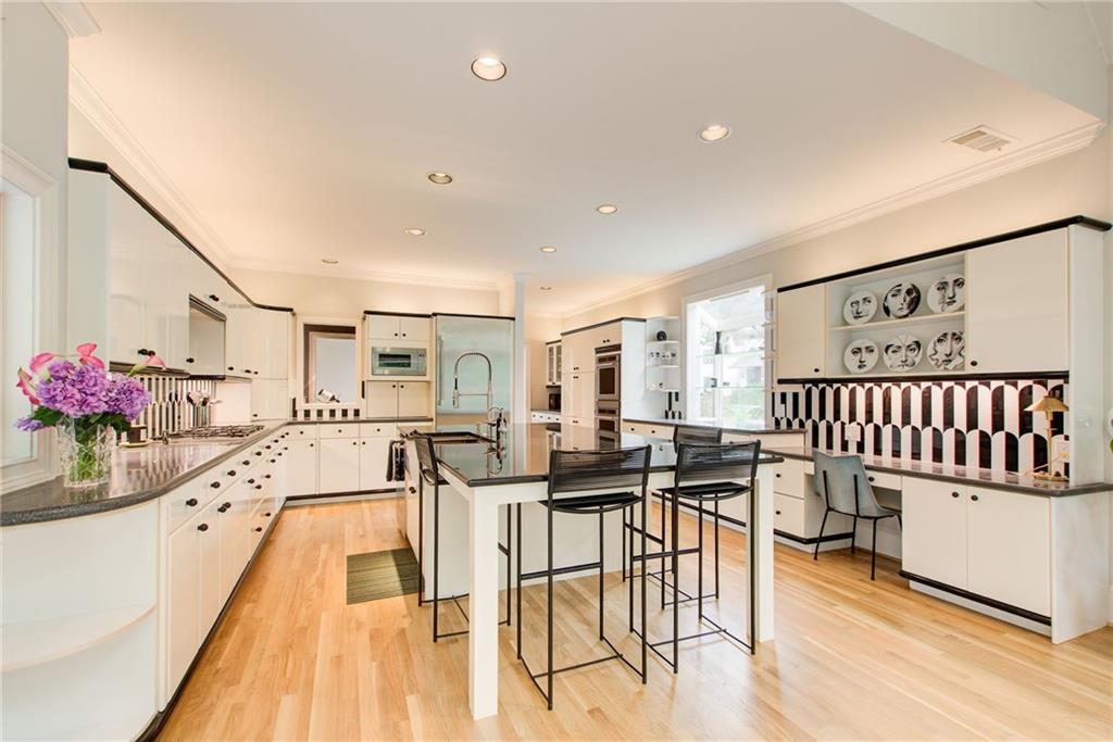 115 Cross Roads Court Atlanta, GA 30327 - Photo 10 of 55 a dining hall with stainless steel appliances kitchen island granite countertop a dining table and chairs with wooden floor