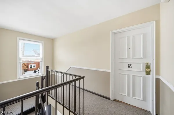 a view of a hallway with windows and stairs