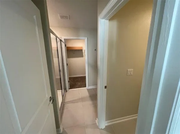 a bathroom with a glass door shower