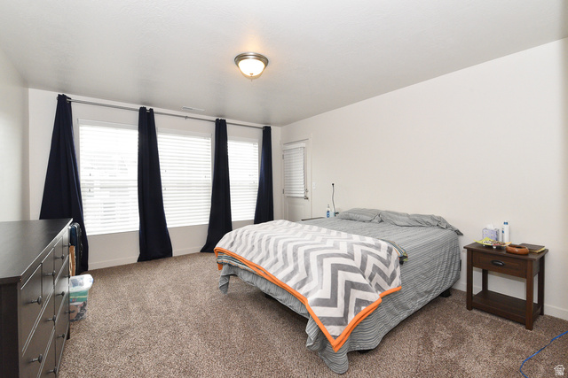 1632 North Apache Road Saratoga Springs, UT 84045 - Photo 16 of 28 Spacious room featuring multiple windows with blinds, a neutral wall color, and textured carpeting