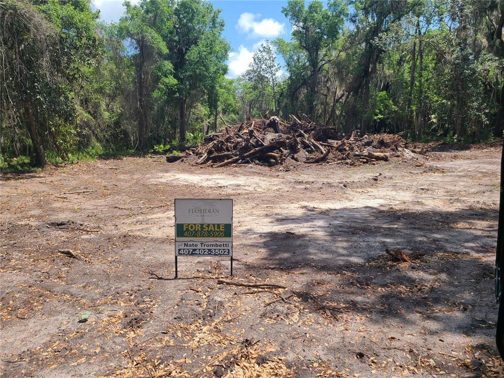 2288 Enterprise Osteen Road Deltona, FL 32738 - Photo 2 of 3 a view of a bench with trees in the background