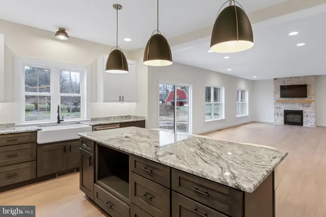 a kitchen with center island and stainless steel appliances