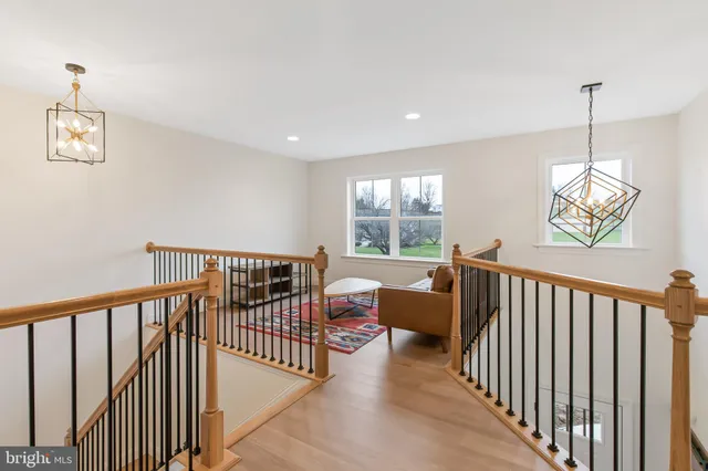 a view of a hallway with windows and furniture