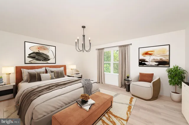 a bedroom with furniture and a flat screen tv