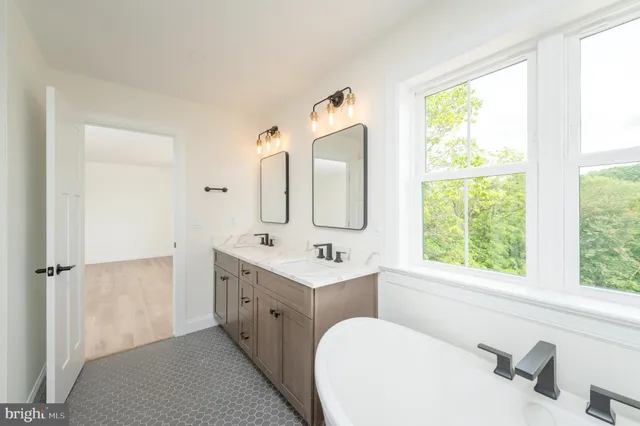 a bathroom with a sink vanity toilet and tub