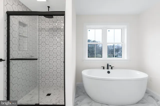 a white bath tub sitting next to a window