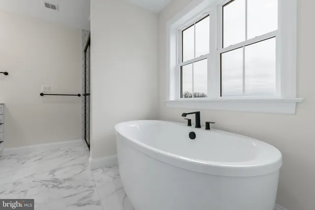 a white bath tub sitting next to a window